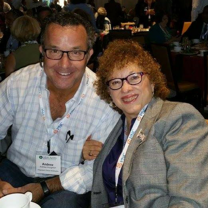 Photo of Joyce Bender and Andrew Houghton smiling together at a conference